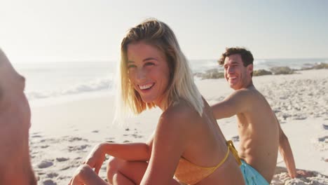 Caucasian-friends-talking-at-beach-