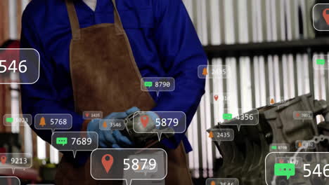 male mechanic holding grinder over workbench in tech workshop, showing animated alert icons