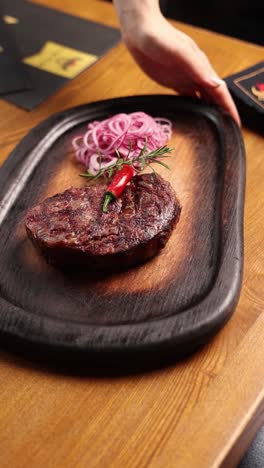 grilled ribeye steak with red onion and chili pepper