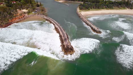 aerial view over the shark bay, revealing the village of evans head - tilt, drone shot