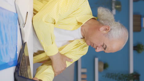 Vertical-video-of-Home-office-worker-old-man-having-a-heart-attack.