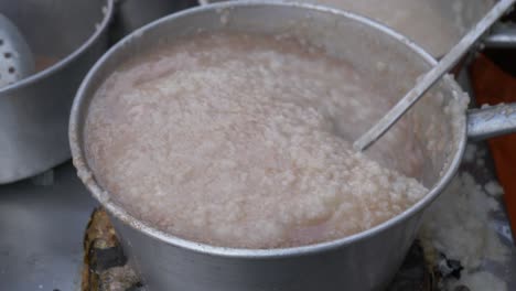 cooking stirring chinese rice congee soup