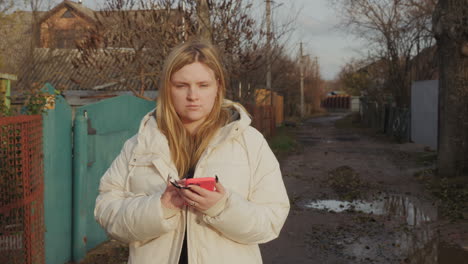 woman using phone in a rural area