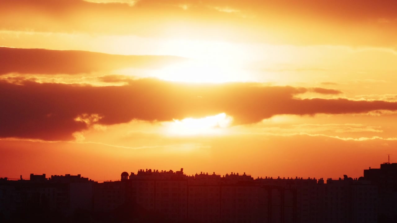 Bright golden sunset illuminating a modern city skyline