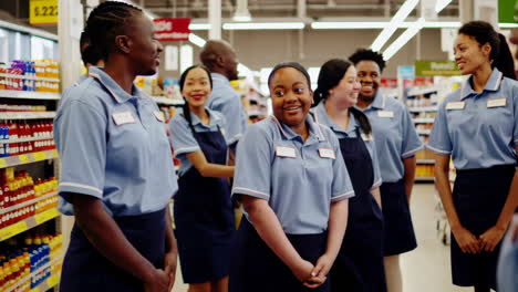 happy and diverse supermarket employees laughing together