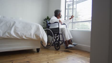 african american senior woman breathing using an oxygen mask at home