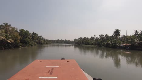 Boating-Kerala-backwaters,-tranquil-canals-with-lush-trees,-Alappuzha,-India