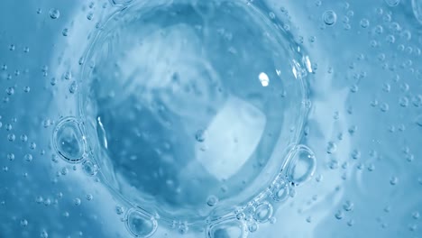 oxygen bubbles in water on a blue abstract background on super slow motion.