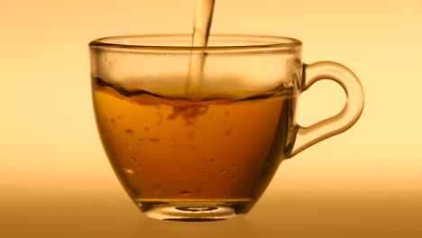 pouring hot beverage into a glass cup