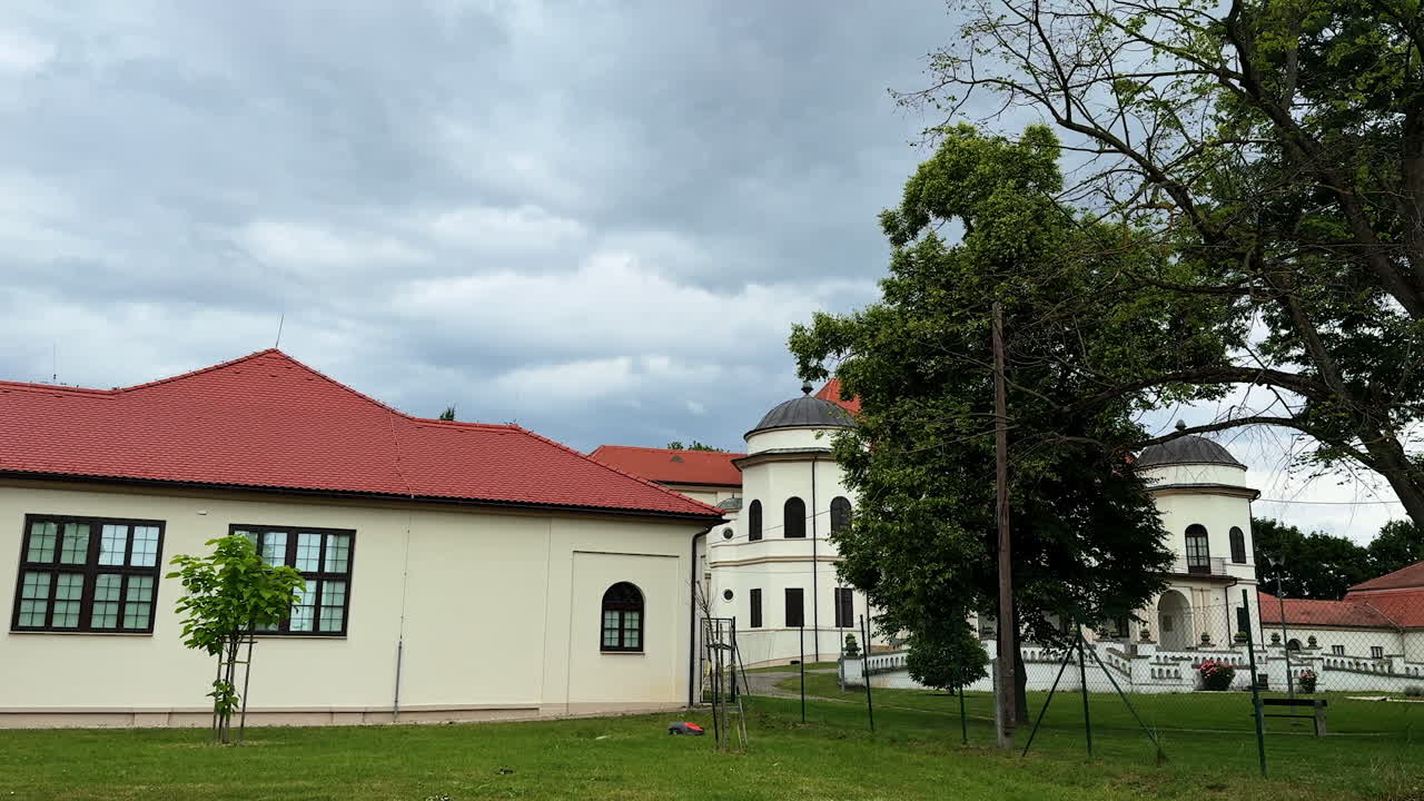 One-storied building with a red roof. Ensemble of a historical buildings in the nature surrounding