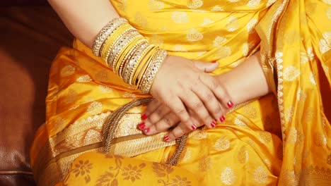 woman in yellow sari with bangles