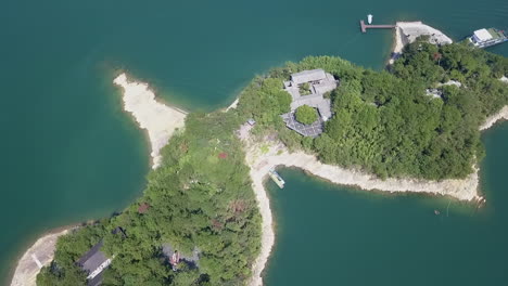 flyover of traditional buildings on small islet, thousand island lake