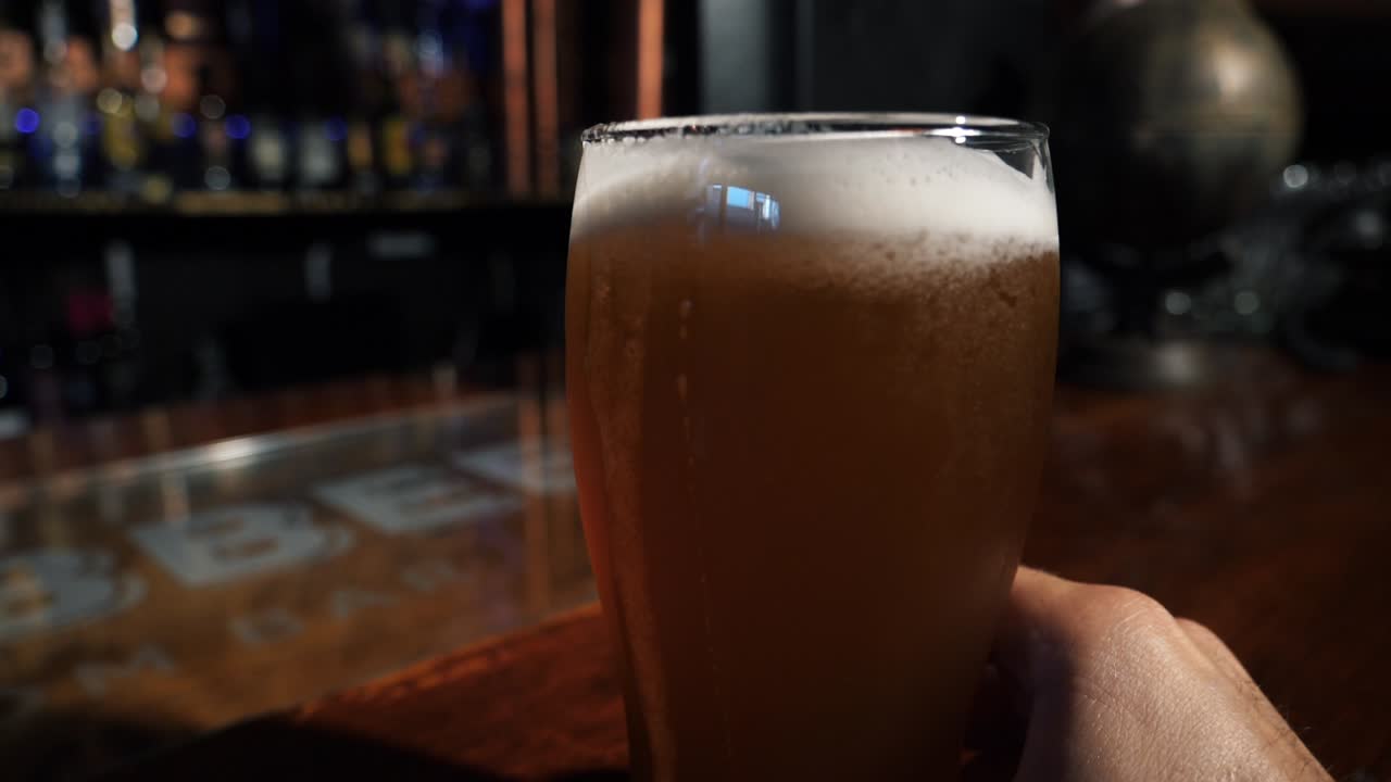 Elin bira bardağını bar tezgahına yerleştirmesi