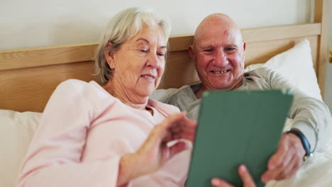 senior, couple and tablet in bed happy