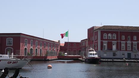 boat near red building with italian flag