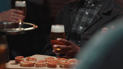 diverse-group-of-friends-making-toast-having-fun-drinking-socializing-hanging-out-in-bar-chatting-sharing-celebration-enjoying-evening-reunion-gathering