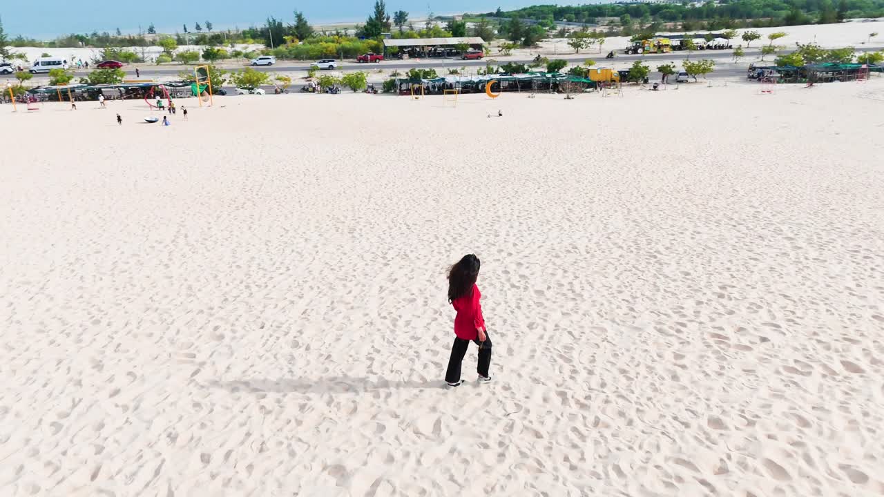 Aerial View Orbit of a Girl Walking in the Desert in Vietnam.