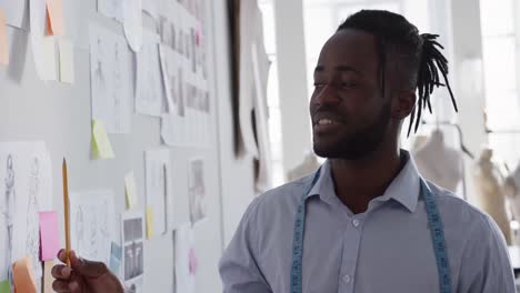 mixed race man working in fashion office