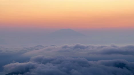 majestic mountain peak above the clouds at sunset
