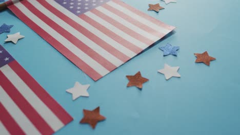 american flags with red and blue stars lying on blue background