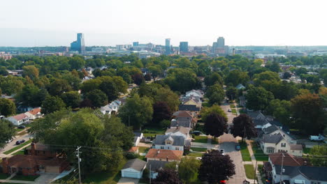 grand rapids michigan city skyline aerial flying over trees houses