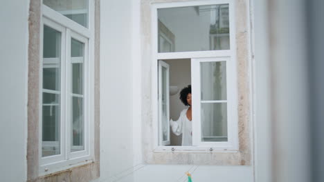 Peaceful-woman-opening-window-at-morning.-African-lady-checking-weather-admiring