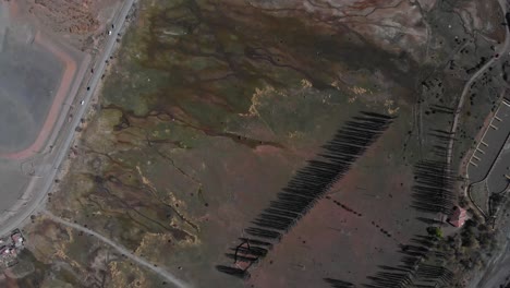 aerial shot showing swamp-like terrain next to a road-4k