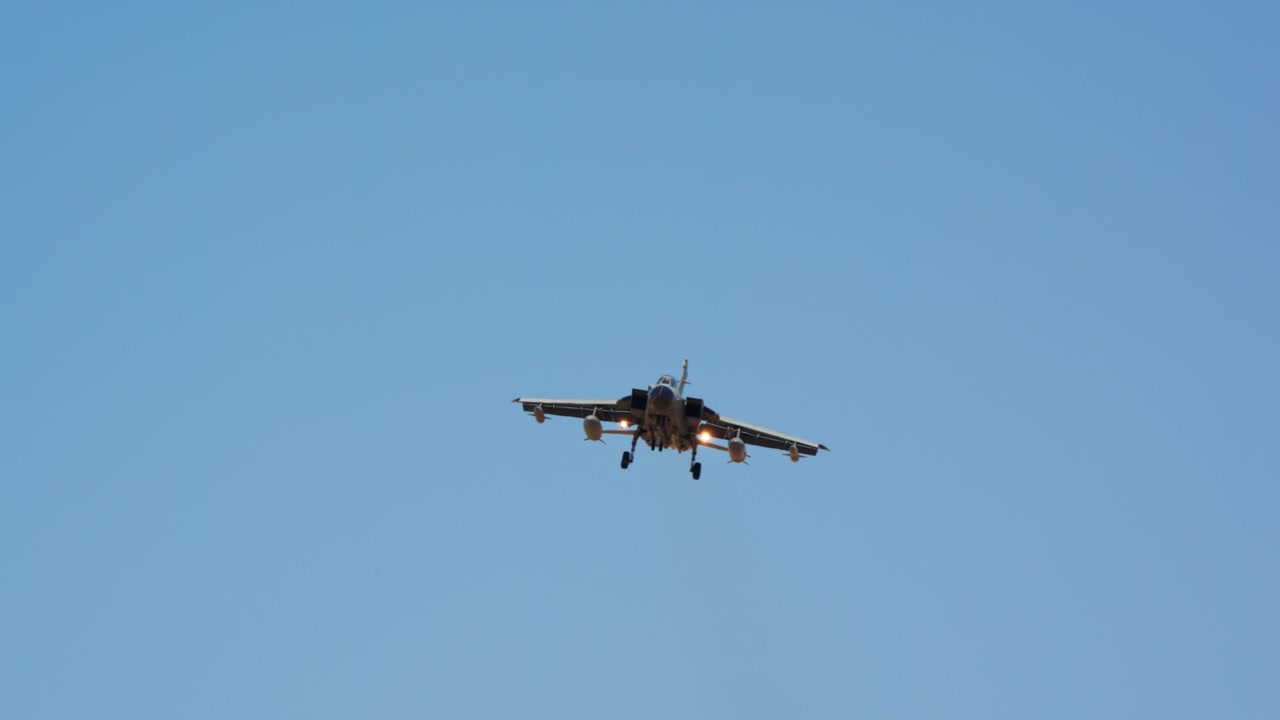 Fighter jet turning on approach seen from below