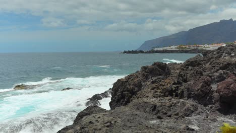 Tenerife-rugged-cliff-coastline,-waves-splashing-against-coast,-Alcala,-static