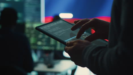 person uses tablet in governmental cyber security room working for russian flag