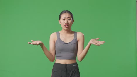 woman in sportswear looking confused