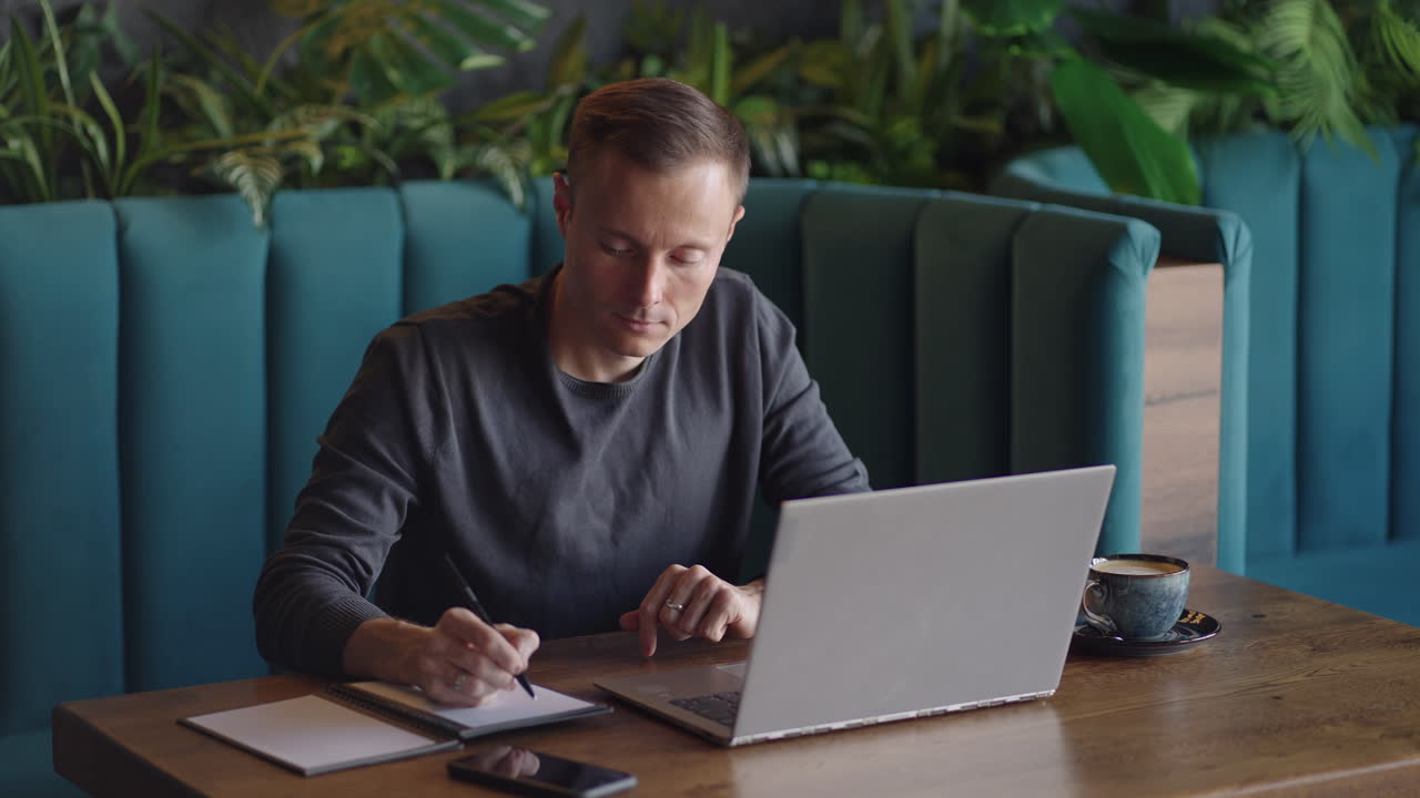 Hispanic latin man college student using laptop computer watching distance online learning seminar class remote university webinar or having virtual classroom meeting in university creative space.