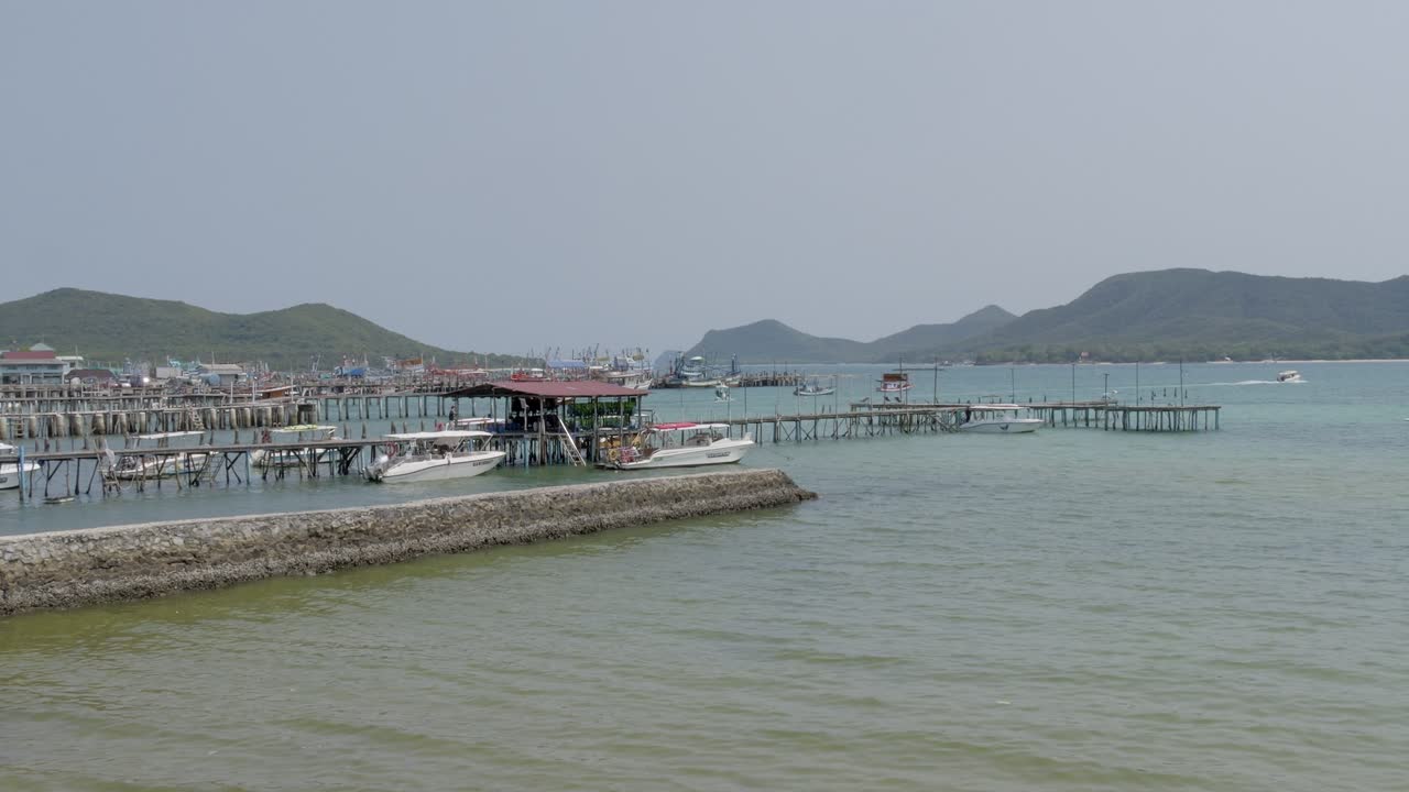 Scenic boat activity at coastal pier thailand nature serene environment elevated viewpoint