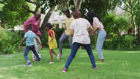 animation of happy african american family playing football in garden