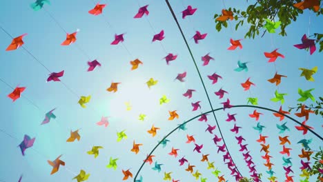 thousands of colorful pinwheels spinning overhead on a sunny windy day