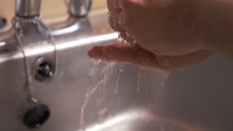 washing hands under the tap with bar of soap