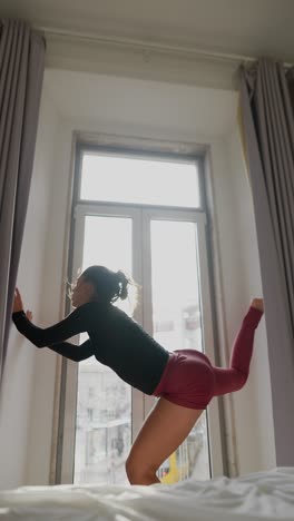 woman dancing in a bedroom with a view