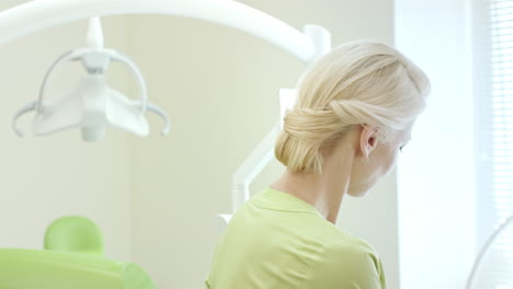 smiling dentist showing dental instruments. portrait of dental professional