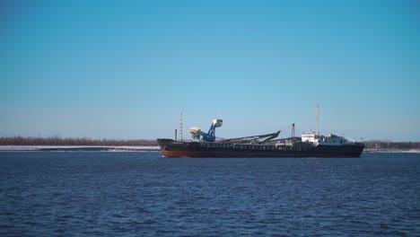 cargo ship on a river in winter