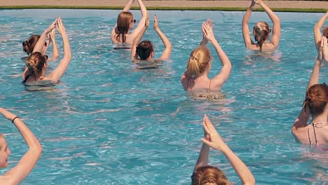 girls are engaged in water aerobics in summer