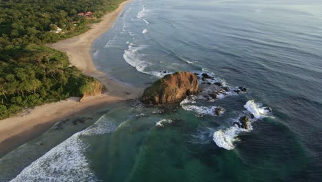 the big bluffs between playa grande and playa ventanas being splashed by waves