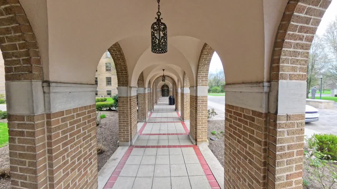 A tranquil view of the iconic brick archway at Saint Charles Preparatory School in Columbus, Ohio. This footage captures the architectural beauty and serene atmosphere of this historic institution.
