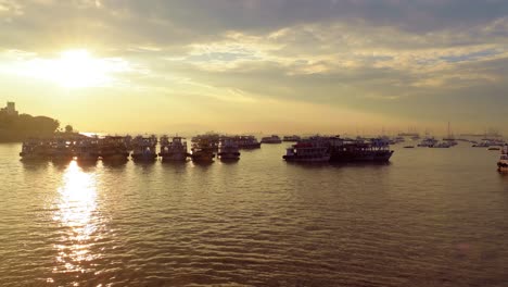 boats on mumbai water at dawn. colaba region of mumbai, maharashtra, india.