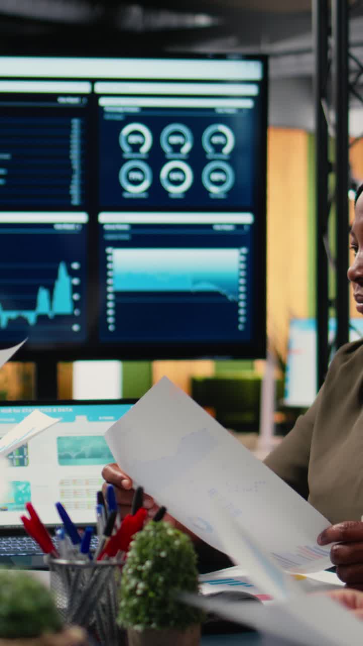 Vertical Video Diverse team of businesswomen gather around the table in a corporate office