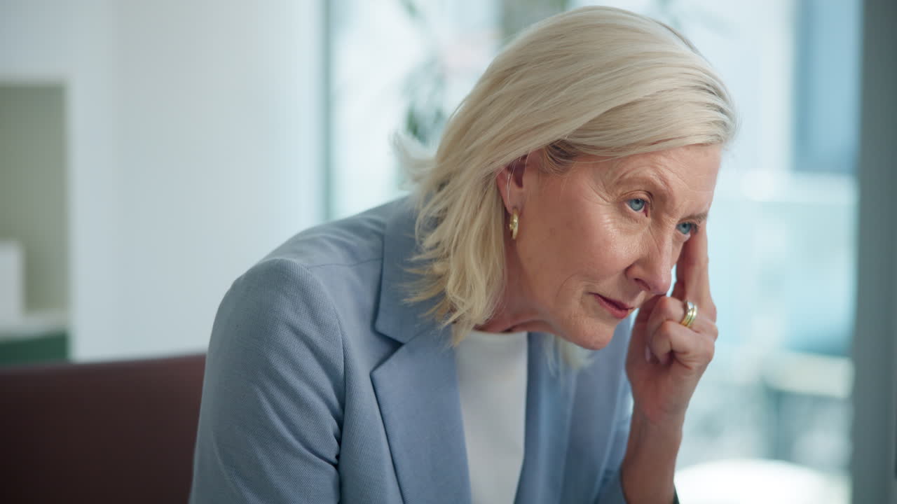 Senior Woman Suffering from Headache Takes a Pill for Relief