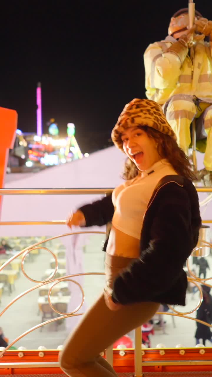 Young Woman Enjoying an Amusement Park at Night