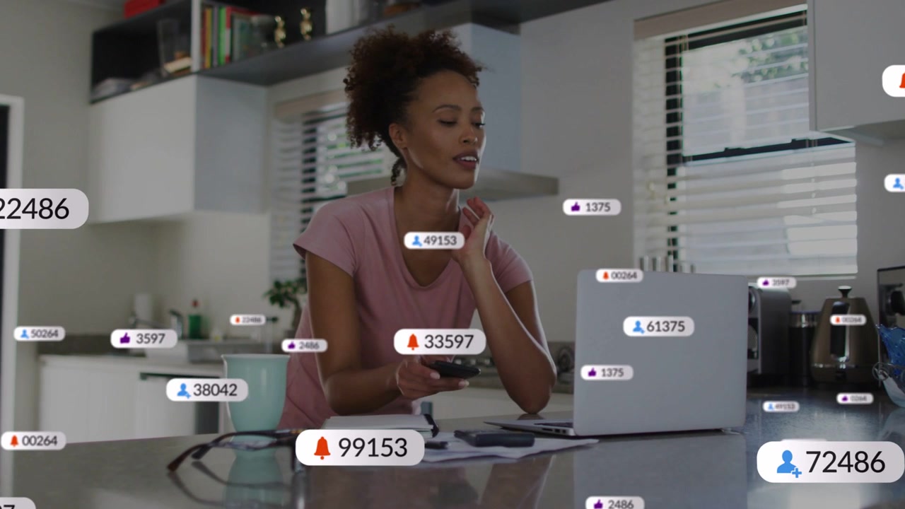 Woman checking phone in kitchen, tapping, spawning HUD badges, then typing on laptop for marketing