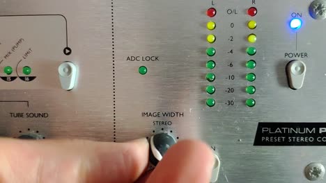 an audio device with knobs and vertical led level meters