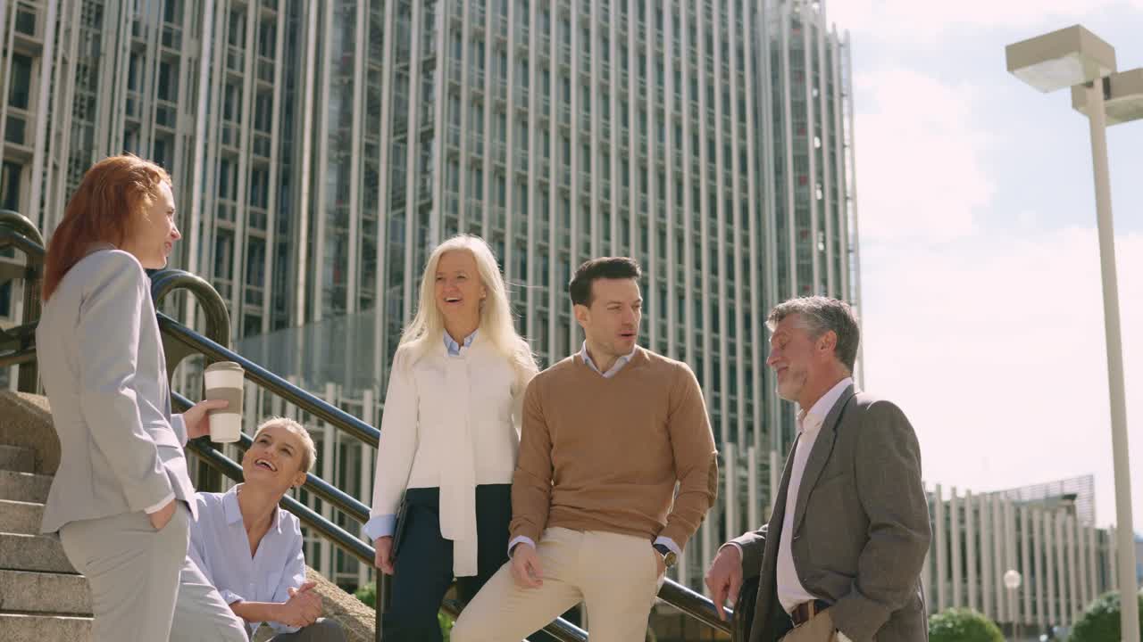 Business people on stairs outside office building