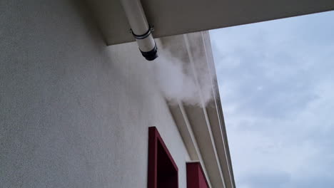 steam comes out from the exhaust pipe of the gas boiler